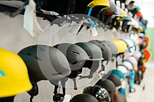 Rows of ski and snowboarding helmets, sports shop