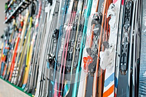 Rows of skis in sports shop, closeup, nobody