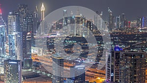 Rows of skyscrapers in financial district and business bay in Dubai aerial night timelapse.