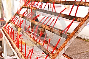 Rows of small candles in a temple