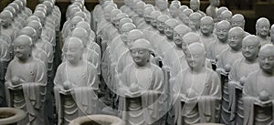 Rows of small stone Buddha statues