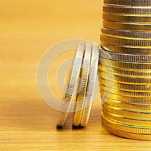 Rows, stacks of coins with blurred background and blank space, square image for finance and business concept