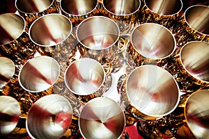 Rows of stamped hemispherical goblets made of steel with external inlay.