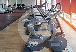 Rows of stationary bikes and treadmills equipment health exercise for bodybuilding