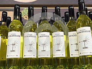 Rows of styrian muskateller white wine bottles lined up on display
