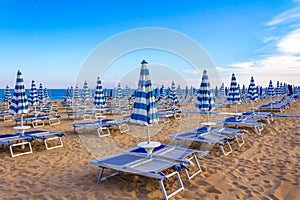 Rows of sunbeds on Lido Di Jesolo empty morning beach Italy