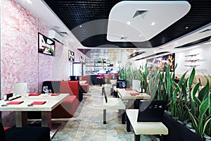 Rows of tables and chairs in small Japanese restaurant.