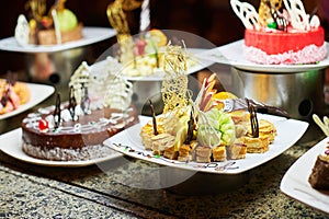 Rows of tasty looking desserts in beautiful arrangements. Sweets on banquet table - picture taken during catering event