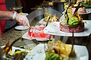 Rows of tasty looking desserts in beautiful arrangements. Sweets on banquet table - picture taken during catering event