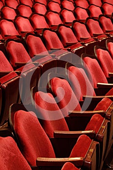 Rows of theater seats in an old vaudeville style theater.