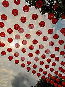 Rows of traditional red Chinese lanterns against the afternoon sky at a Chinese temple
