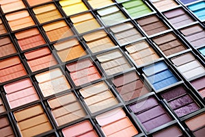 rows of unlabeled eye-shadow palettes