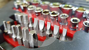 Set of steel bits and socket for bits. Toolkit drills closeup