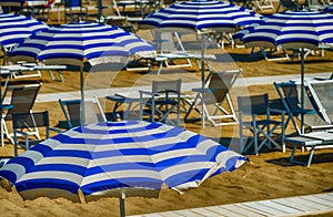 Rows of white and blue beach umbrellas