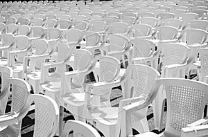 Rows of white chairs at concert