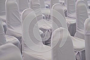 Rows of white chairs in the presentation room