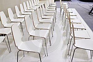 Rows of white chairs in presentation room