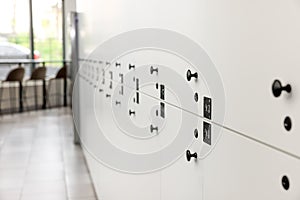 Rows of white lockers in modern hostel