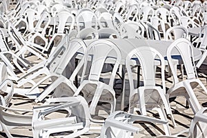 Rows of white plastic chairs.