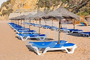 Rows of wicker parasols and beach beds