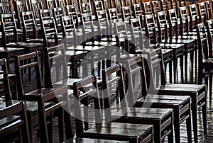 rows of wooden chairs - monotony, no alternative, monotony, retrograde, totalitarianism, colony