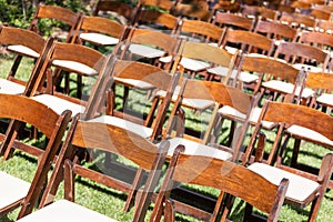 Rows of Wooden Event Chairs at Wedding Venue Abstract