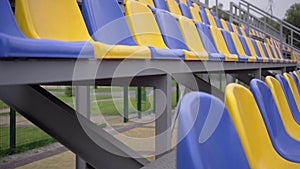 Rows of Yellow and Blue Plastic Seats On Empty Tribune of  Stadium, 4k