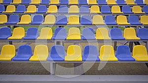 Rows of Yellow and Blue Plastic Seats On Empty Tribune of  Stadium, 4k