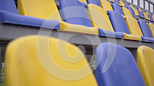 Rows of Yellow and Blue Plastic Seats On Empty Tribune of Stadium, 4k