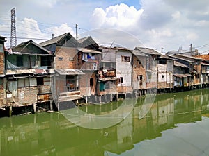 Roxy mas, JakarSlum house located in a densely populated area on the river side