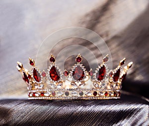 Royal crown with red stones, garnet, crystals.