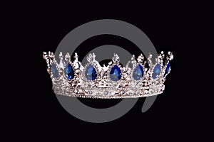 Royal crown with sapphire isolated on black background