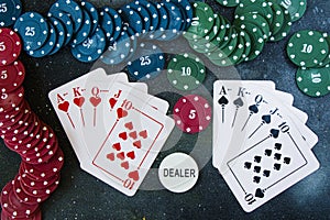 Royal flash poker and blackjacks cards on the dark background