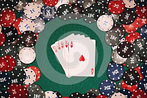 Royal flush on the background of gaming chips on the green table in the casino