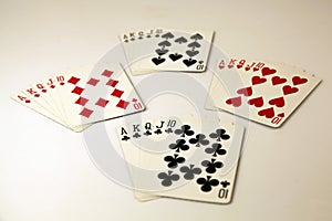 Royal flush cards poker hand in the four suits