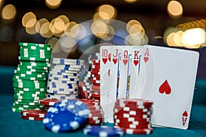 Royal flush combination with poker chips in casino