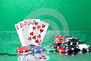 Royal Flush combination under the water drops against green background. Online gambling. Betting.