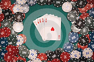 Royal flush in a game of poker on the background of a green table with gaming chips