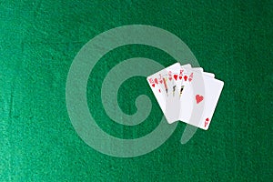 Royal flush of hearts on green background