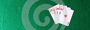 Royal flush of hearts on green background