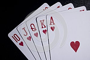 royal flush poker card on dark background