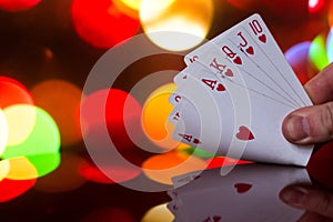 Royal flush poker cards combination on blurred background casino luck fortune card game