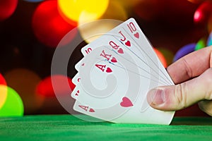 Royal flush poker cards combination on blurred background casino luck fortune card game