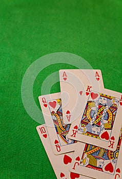 Royal flush poker cards combination on green background casino game fortune luck