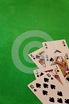 Royal flush poker cards combination on green background casino game fortune luck