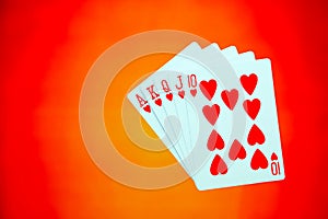Royal flush sequence of playing cards on abstract colorful background