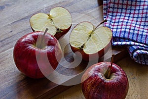 Royal Gala apples and cloth on wooden background with copyspace