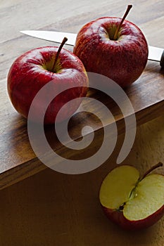 Royal Gala apples and knife on wooden background with copyspace