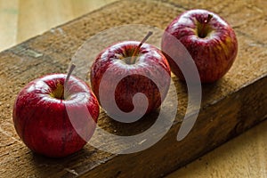 Royal Gala apples on rough rustic wooden background with copy-space