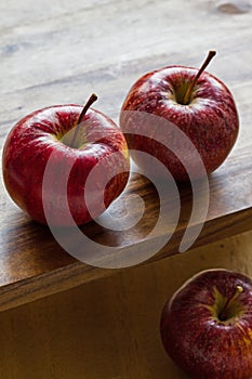 Royal Gala apples on wooden background with copyspace